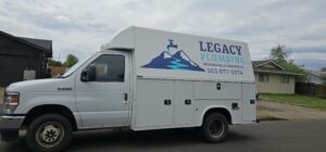 White service van parked on street with 